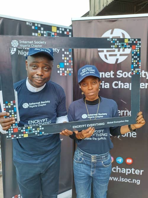 A man and a woman wearing Internet Society Nigeria Chapter shirts